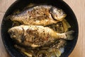ÃÂ Cooked dorado fish with onions in a pan